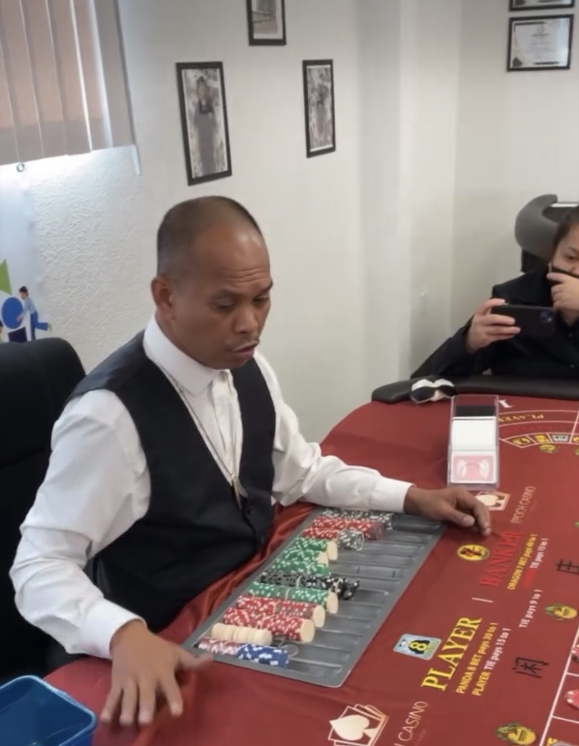 Instructor demonstrating professional dealing technique